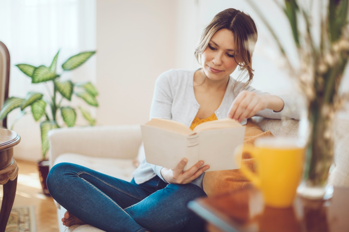 Woman relaxed reading a book.
