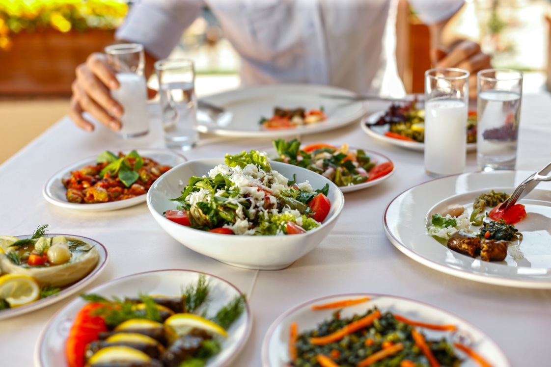 Dinner table with plates of food and glasses of water