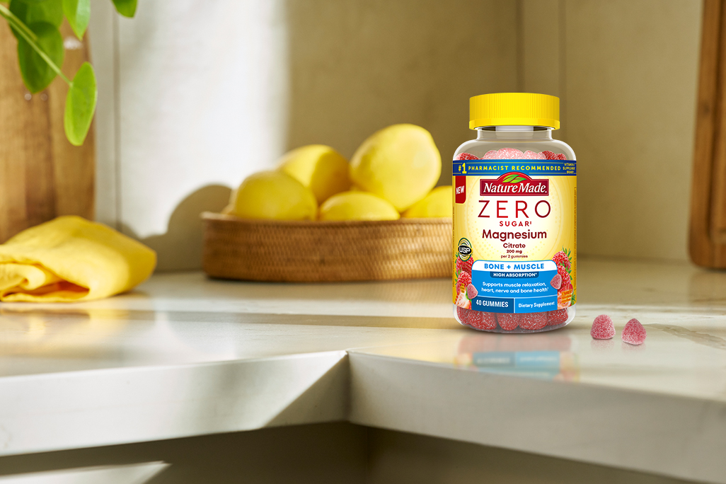 Nature Made Zero Sugar Magnesium in a bright, sunny kitchen with 2 gummies on the counter. 