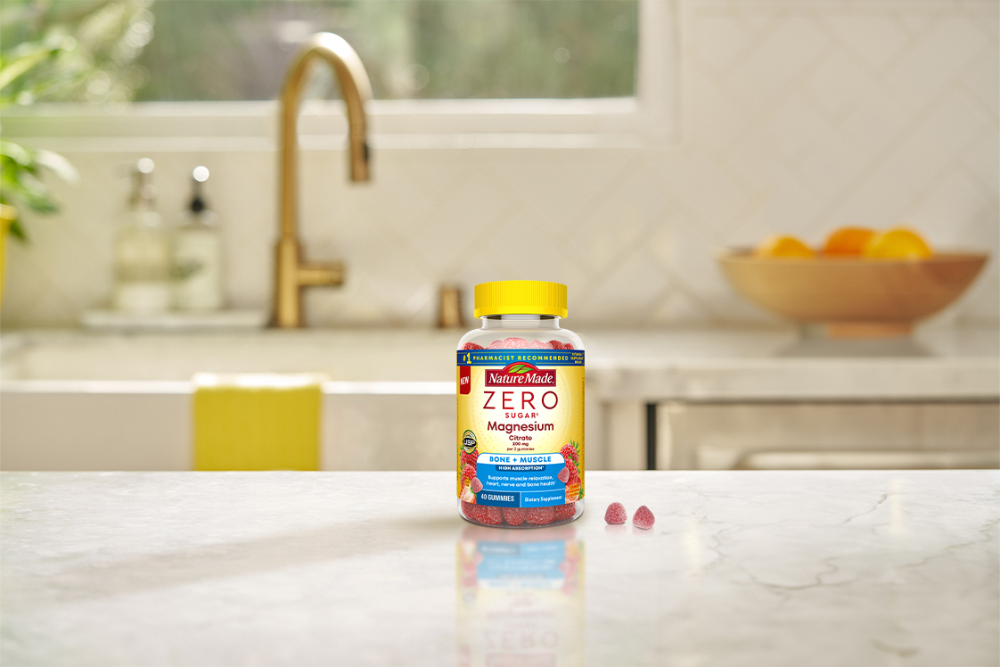 Nature Made Zero Sugar Magnesium gummies on a kitchen countertop with natural light.