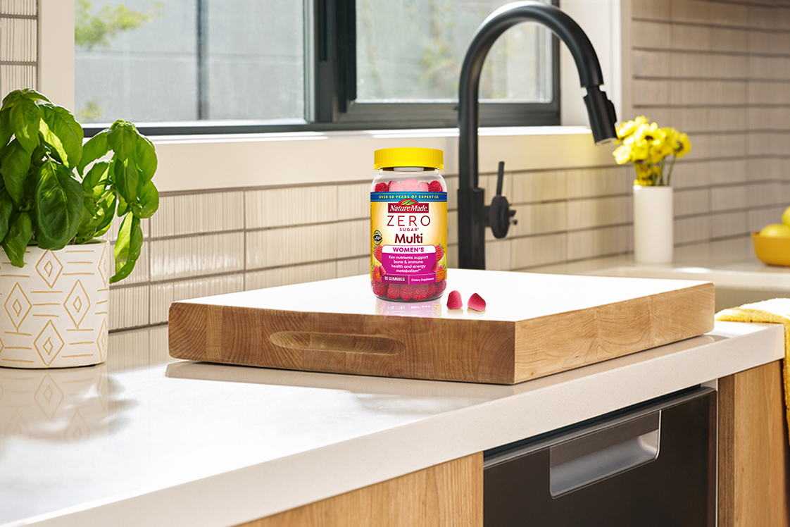 Nature Made Zero Sugar Women’s Multivitamin gummies on a kitchen cutting board.