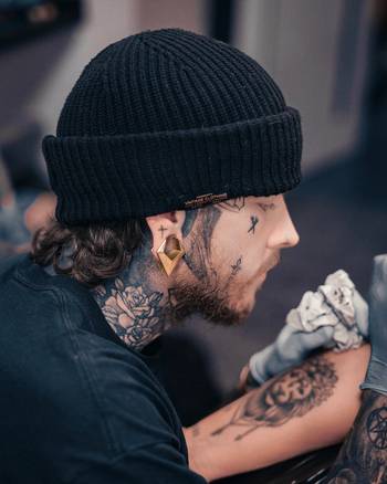 cool alternative tattoo artist wearing Gold Triangle Surgical Steel Saddle Ear Plug / Gauge
