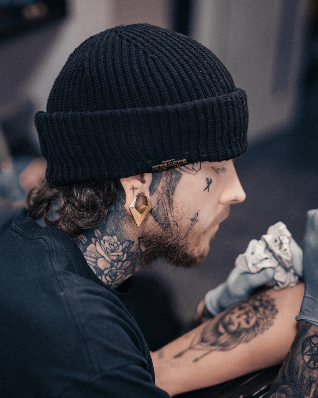 cool alternative tattoo artist wearing Gold Triangle Saddle Plug / Tunnel / Gauge