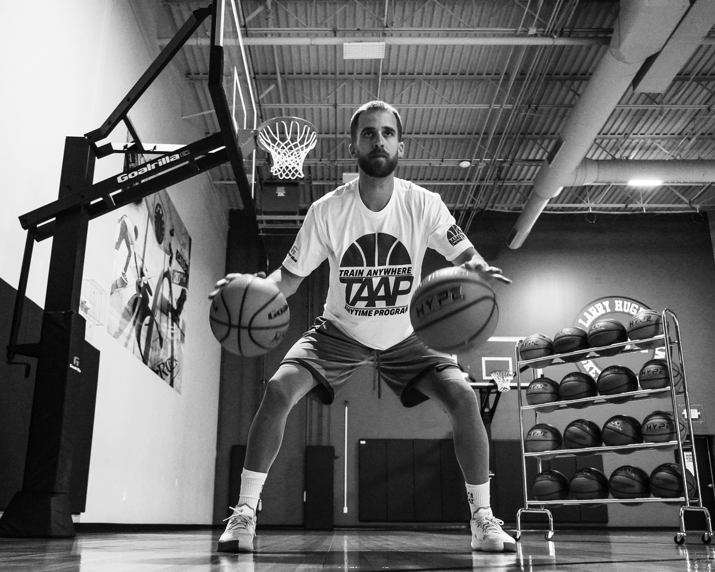 basketball player with indoor basketball hoop dribbling
