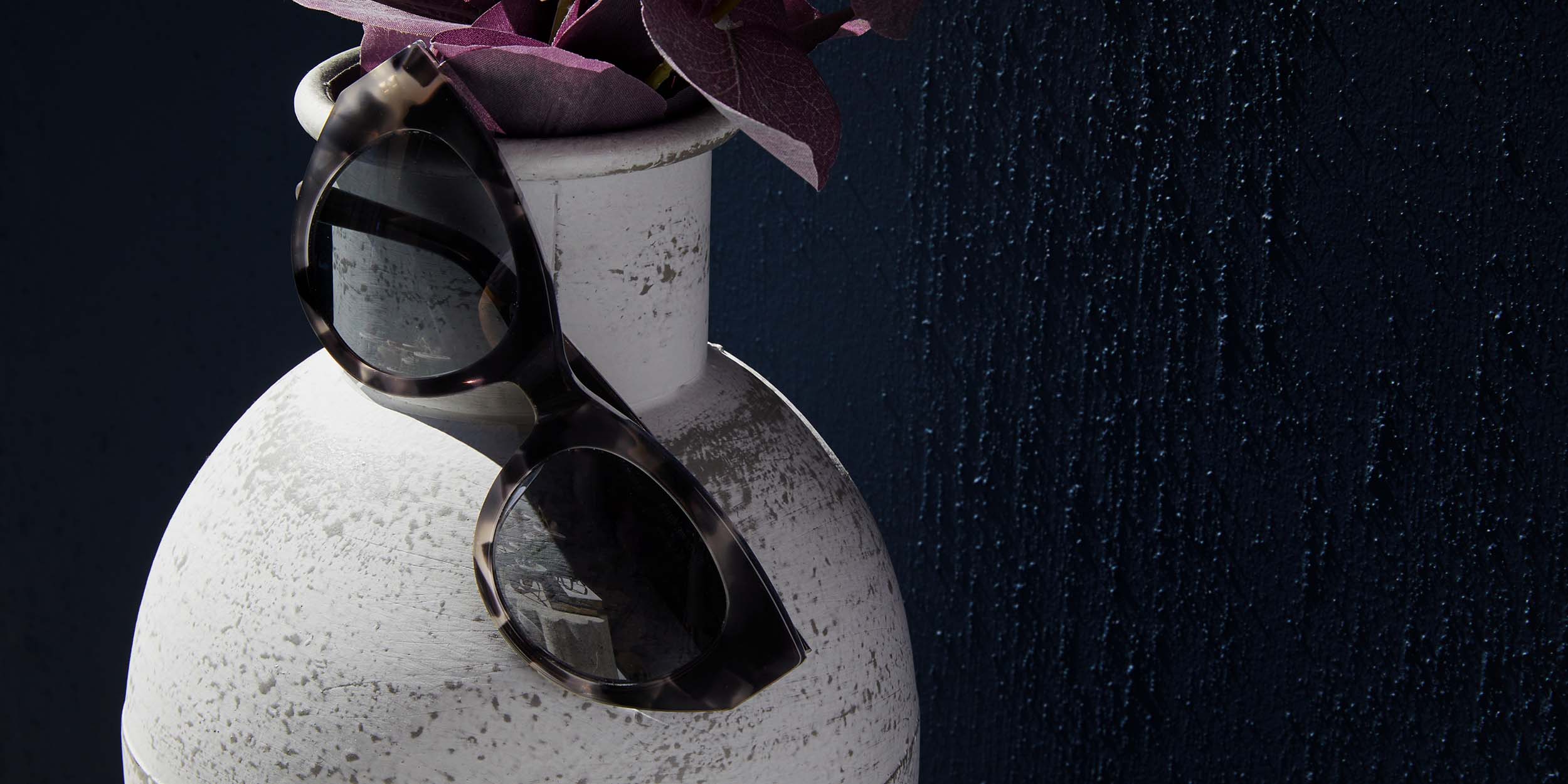 Photo Details of Jackie Sun Grey & Onyx Sun Glasses in a room