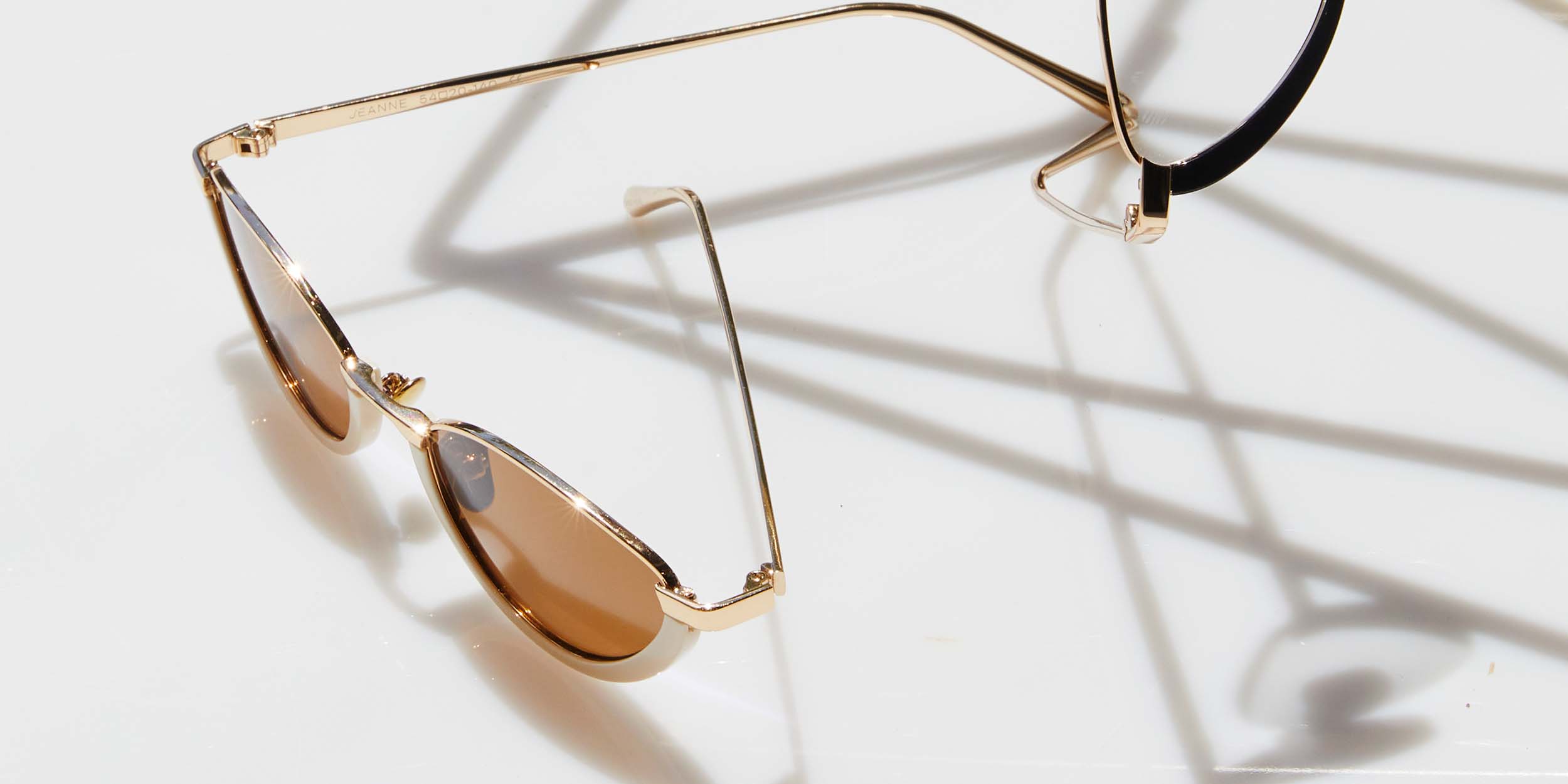 Photo Details of Jeanne Sun Cobalt & Gold Sun Glasses in a room