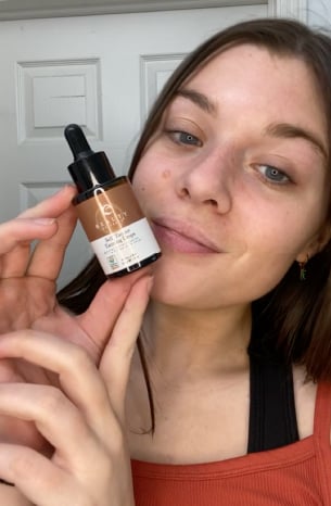 Woman Reviewing Self Tanner Drops 