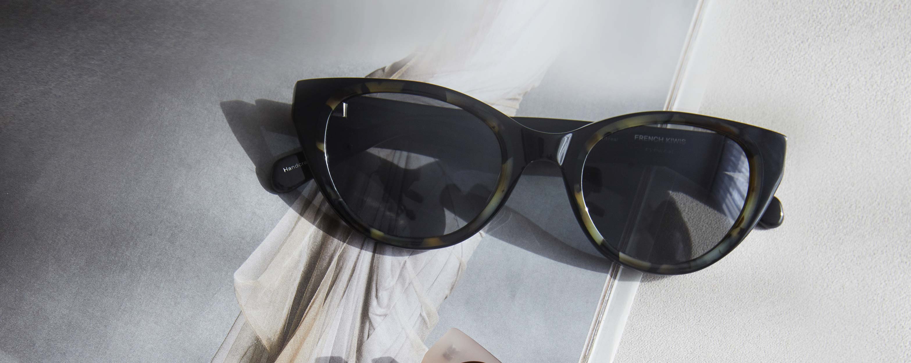 Photo Details of Colette Sun Creme Sun Glasses in a room