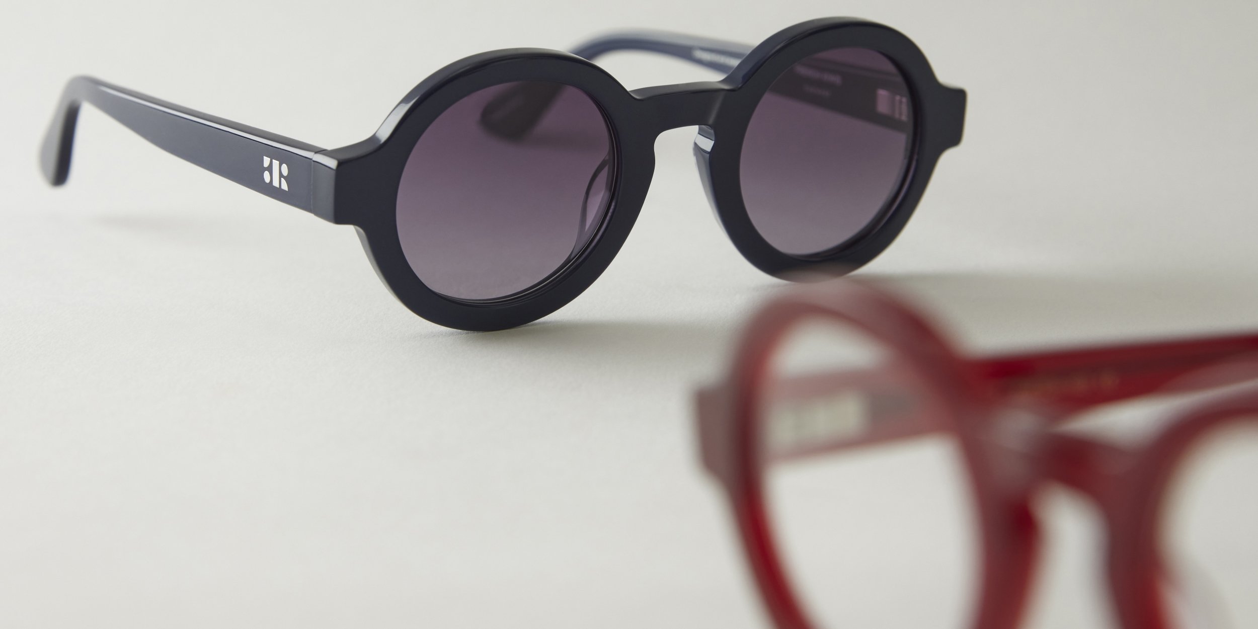 Photo Details of Lola Sun Nude Sun Glasses in a room