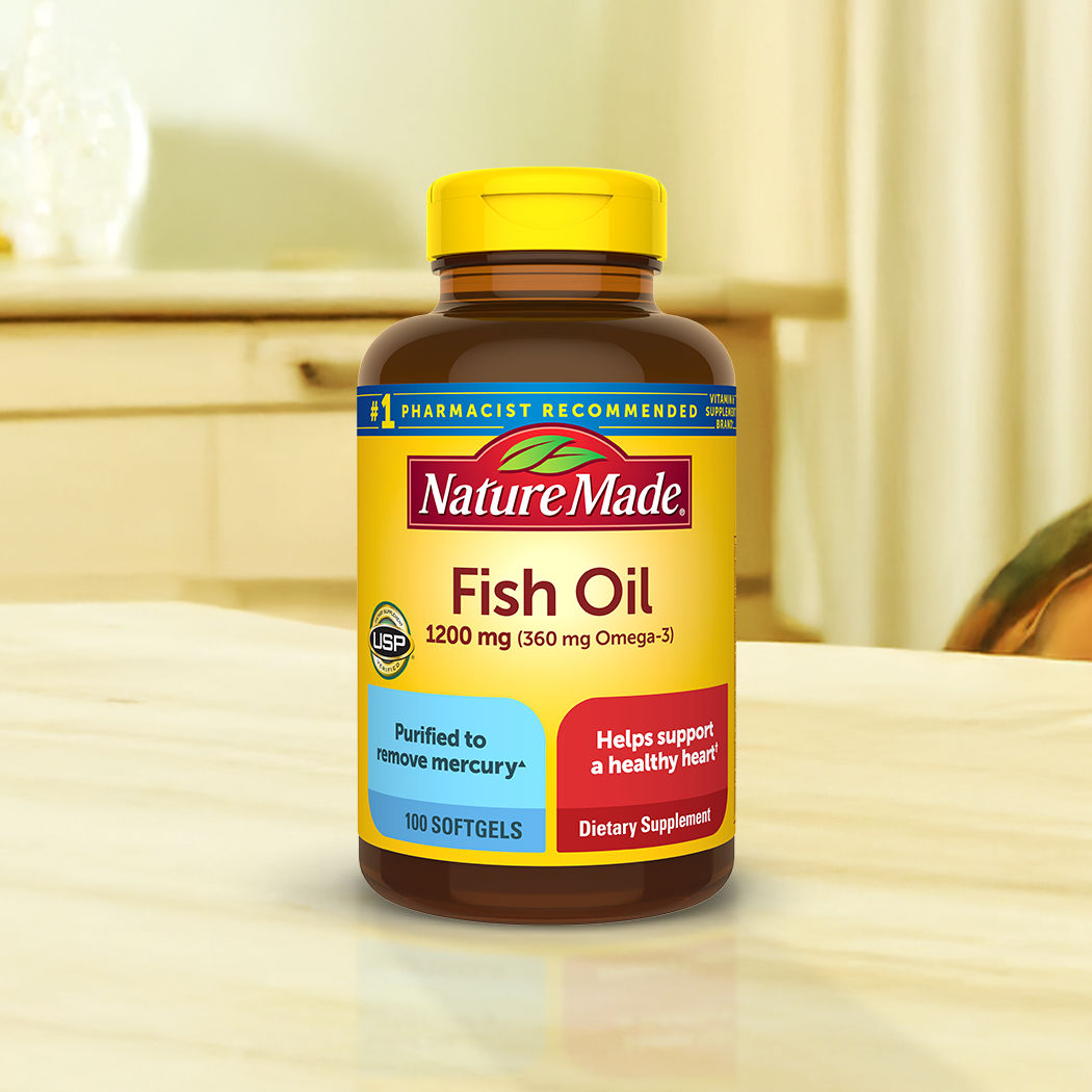 Nature Made Fish Oil supplements on a wooden table.
