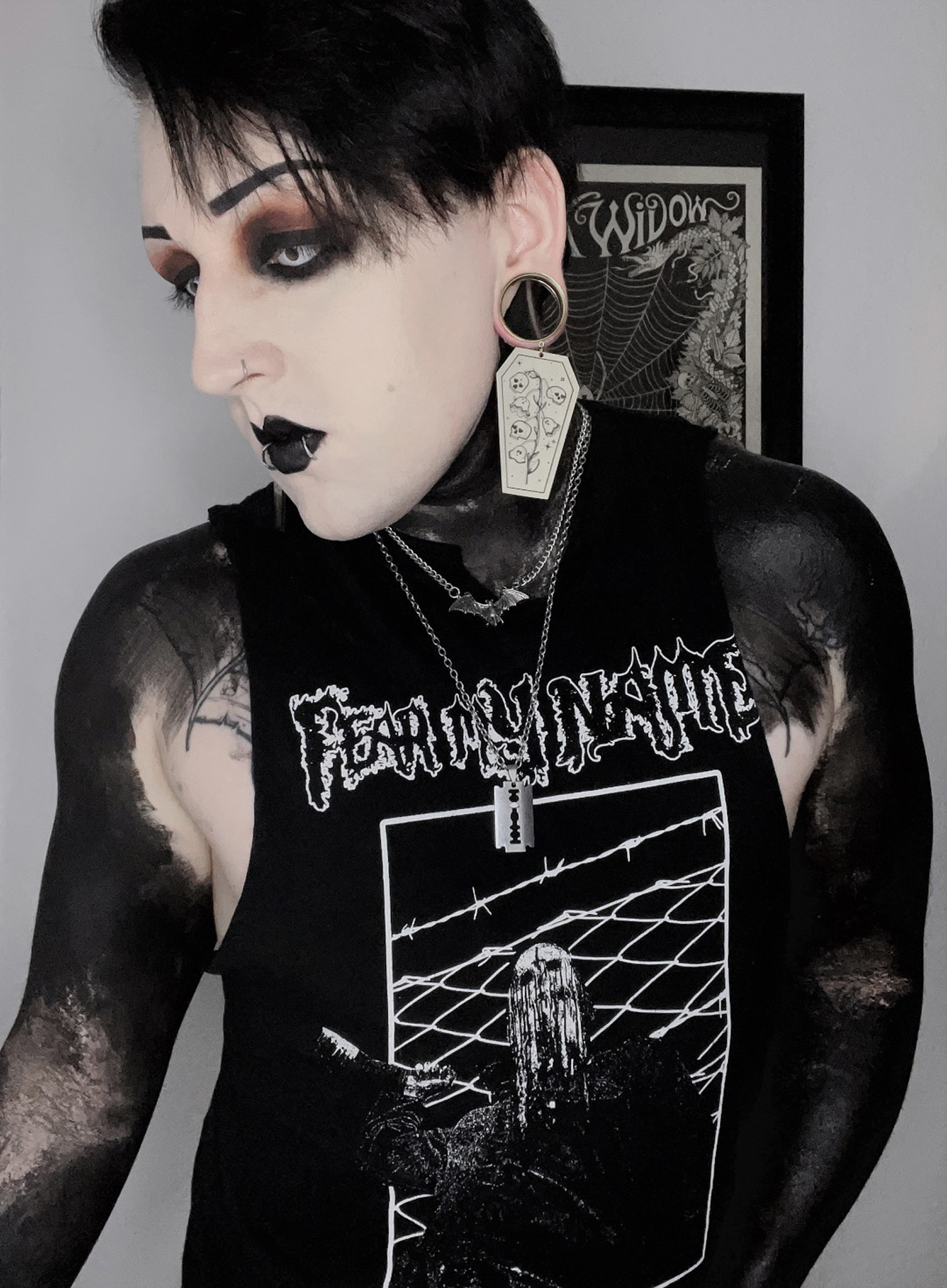 Alternative Tattooed man wearing Gold Dead Flowers Coffin Dangle Plug Earrings
