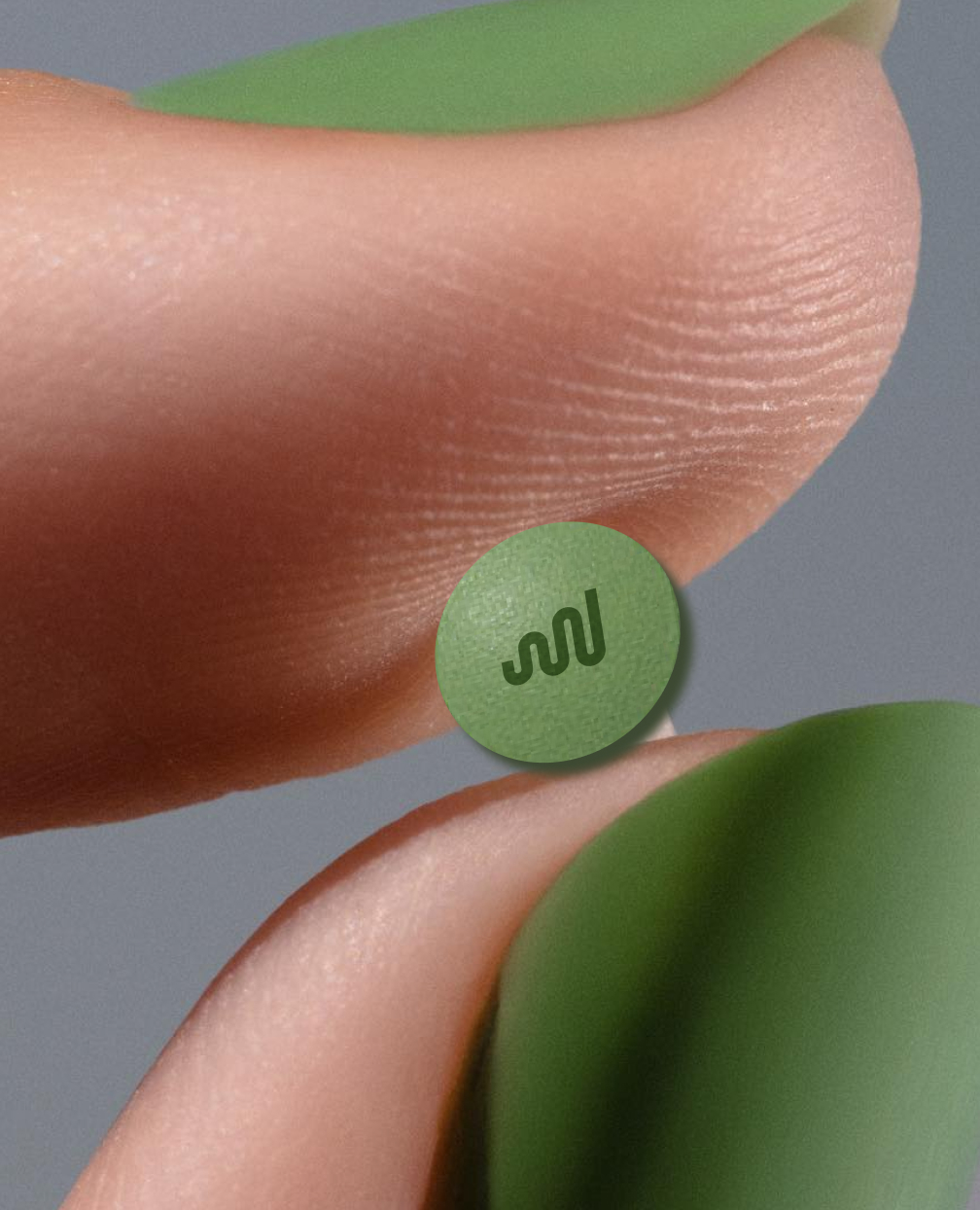 Fingers holding prescription pill