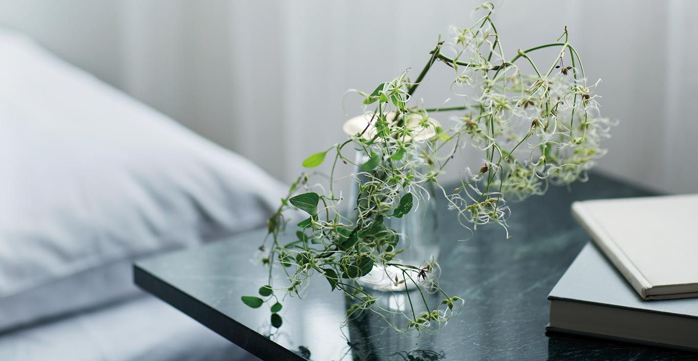  Clear LUNA vase sitting on a marble bedside table  