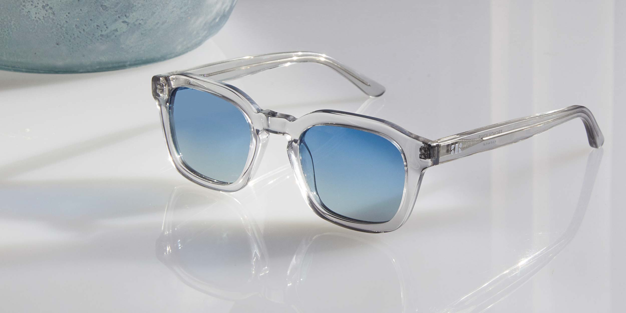 Photo Details of Oscar Sun Clear Mocha Sun Glasses in a room