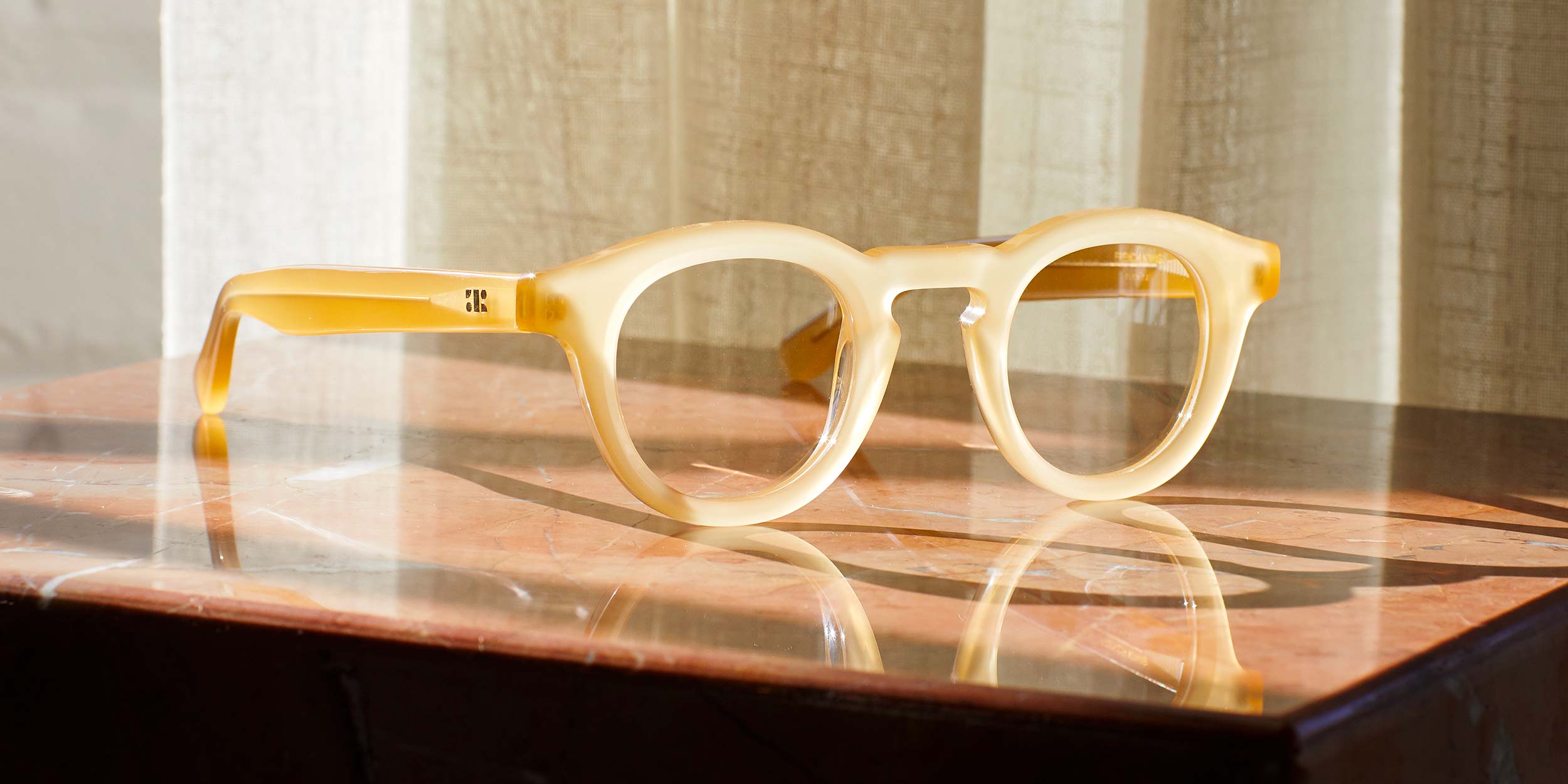 Photo Details of Jude Clear Mocha Reading Glasses in a room