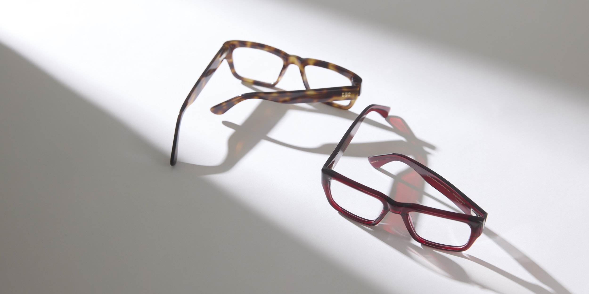 Photo Details of Henri Blue Light Clear Burgundy Blue Light Glasses in a room