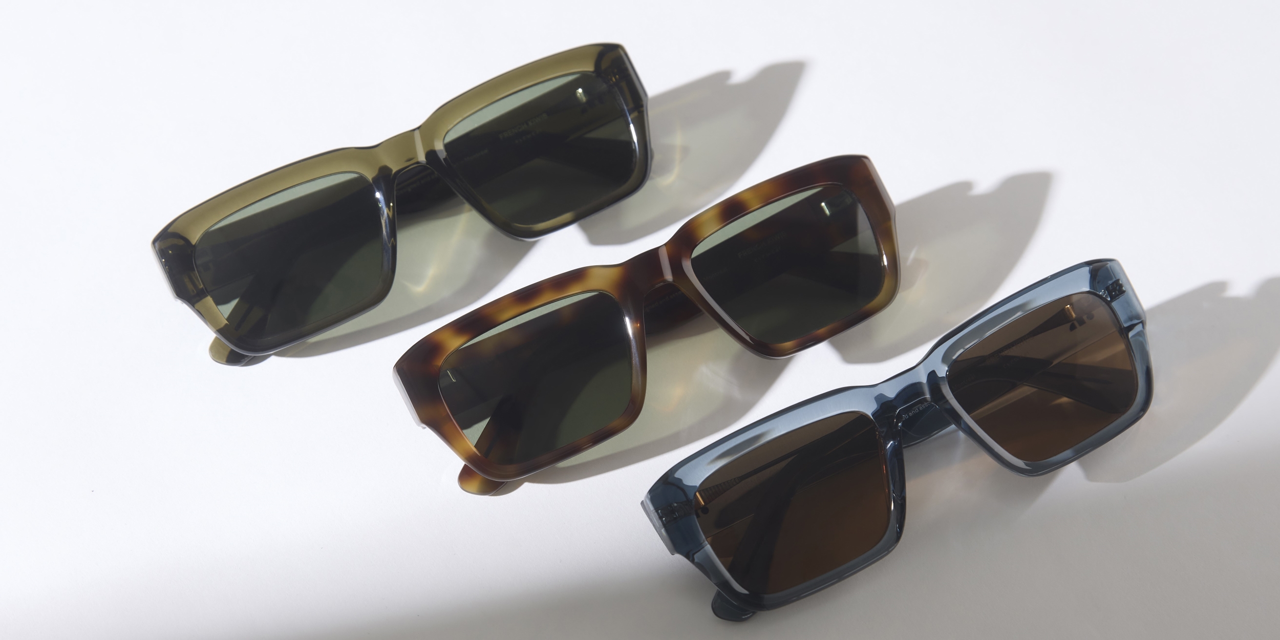 Photo Details of Henri Sun Clear Dark Olive Sun Glasses in a room