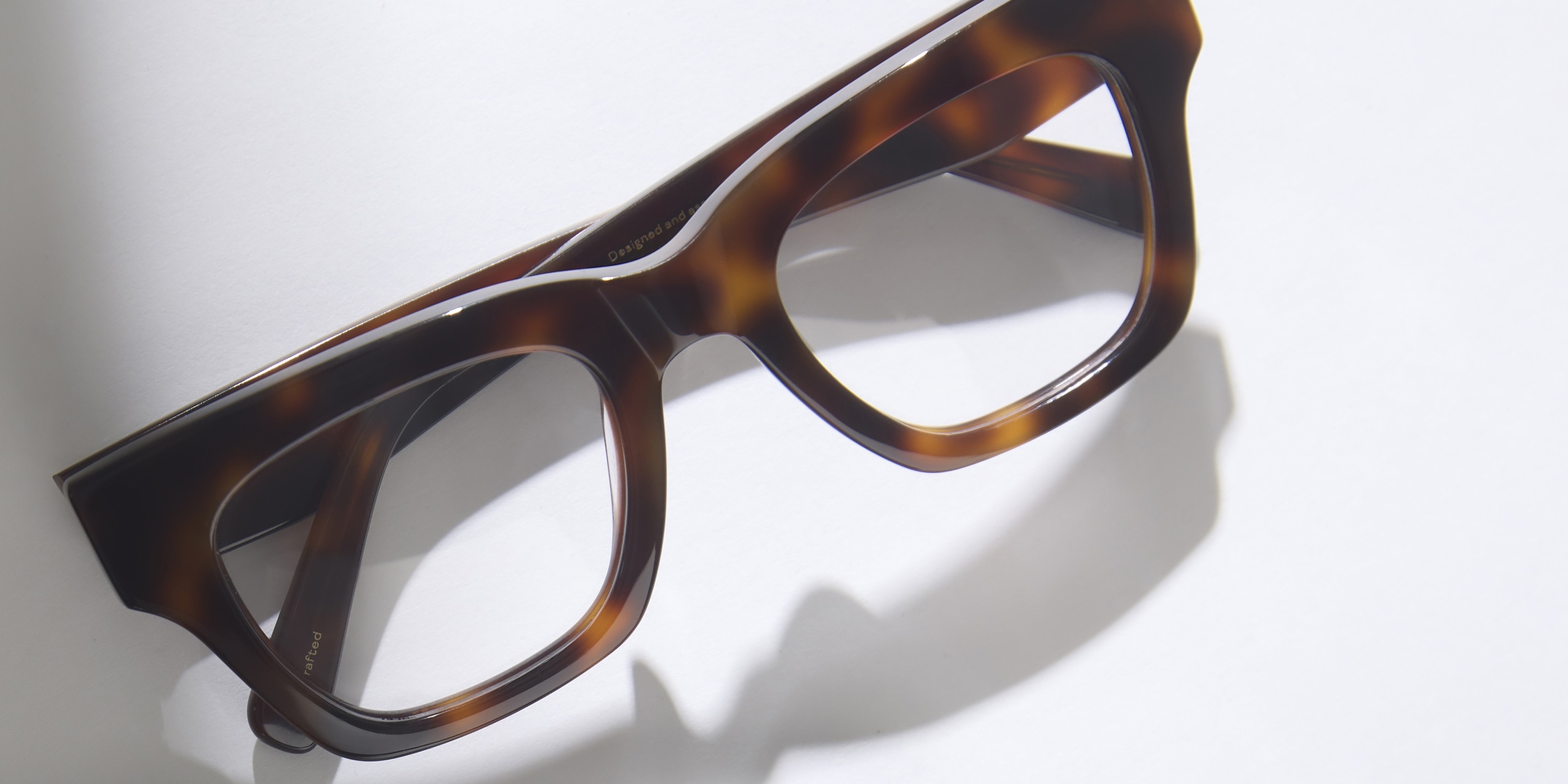 Photo Details of Rosalie Dark Grey Tortoise Reading Glasses in a room