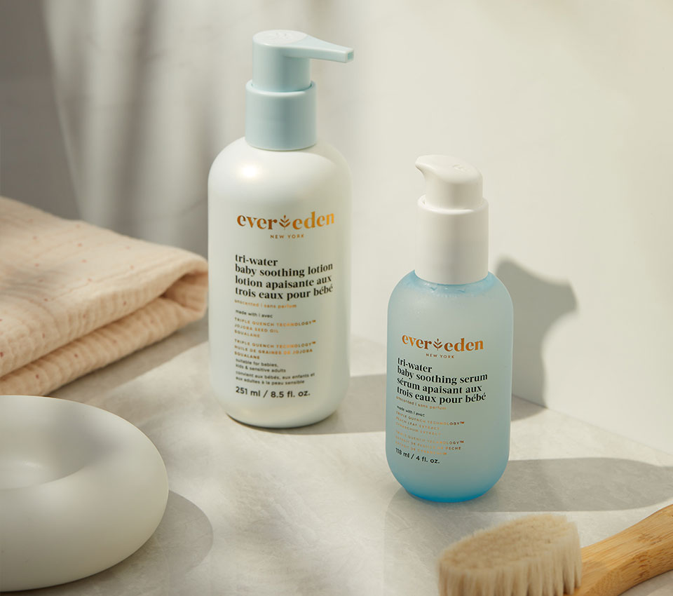 Evereden skincare bottles on bathroom counter with towel and brush.