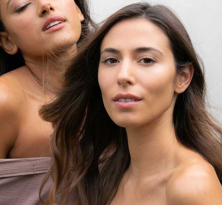 Two women showing skin with Clean Science