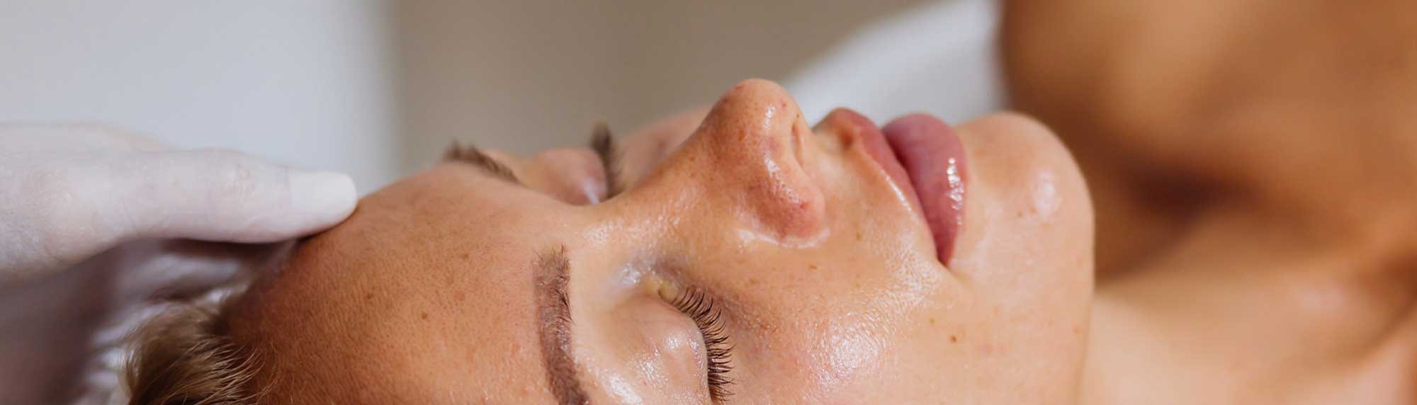 Woman receiving a professional skin treatment in salon