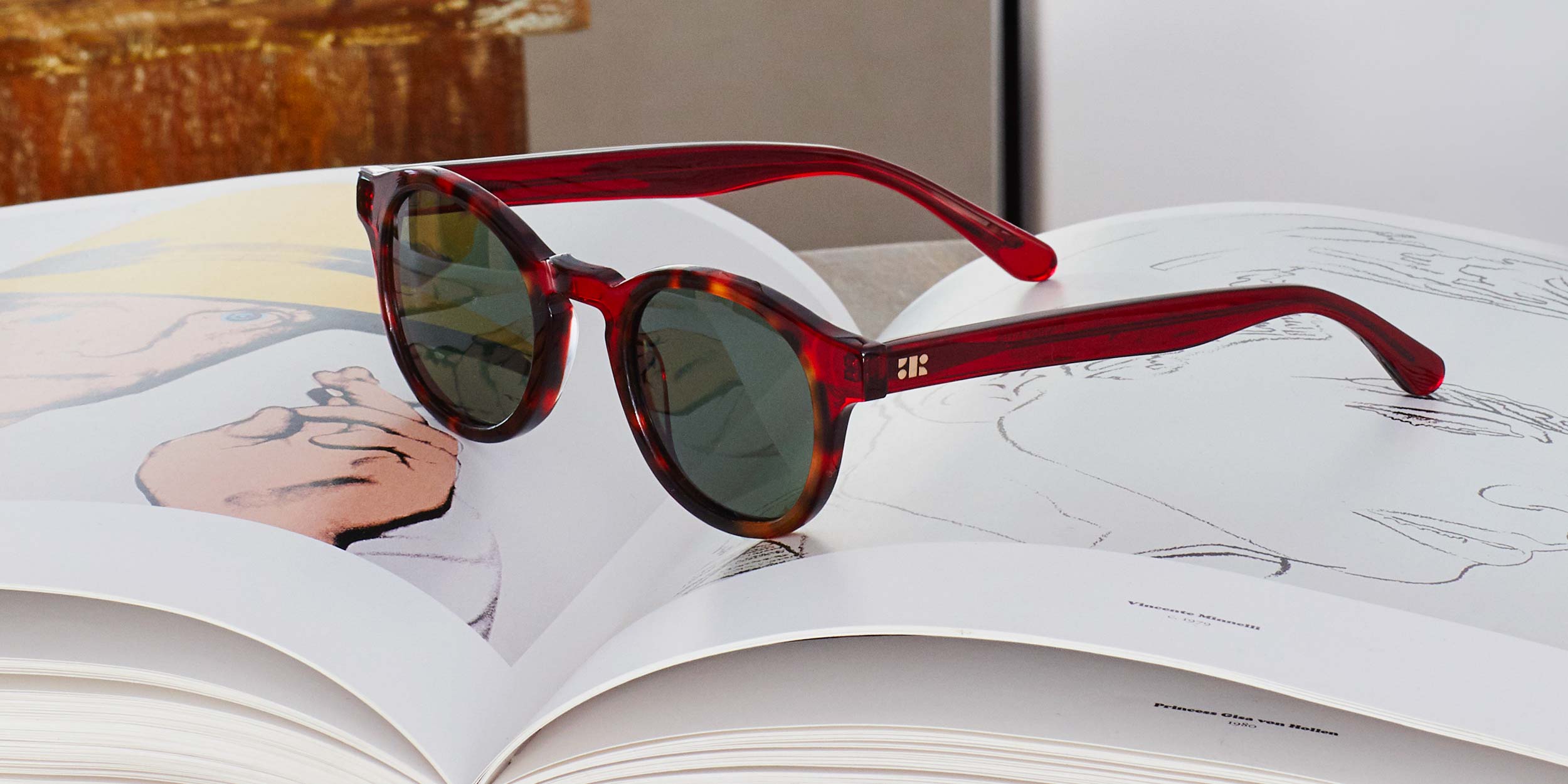 Photo Details of Alexis Sun Midnight Blue Marble Sun Glasses in a room