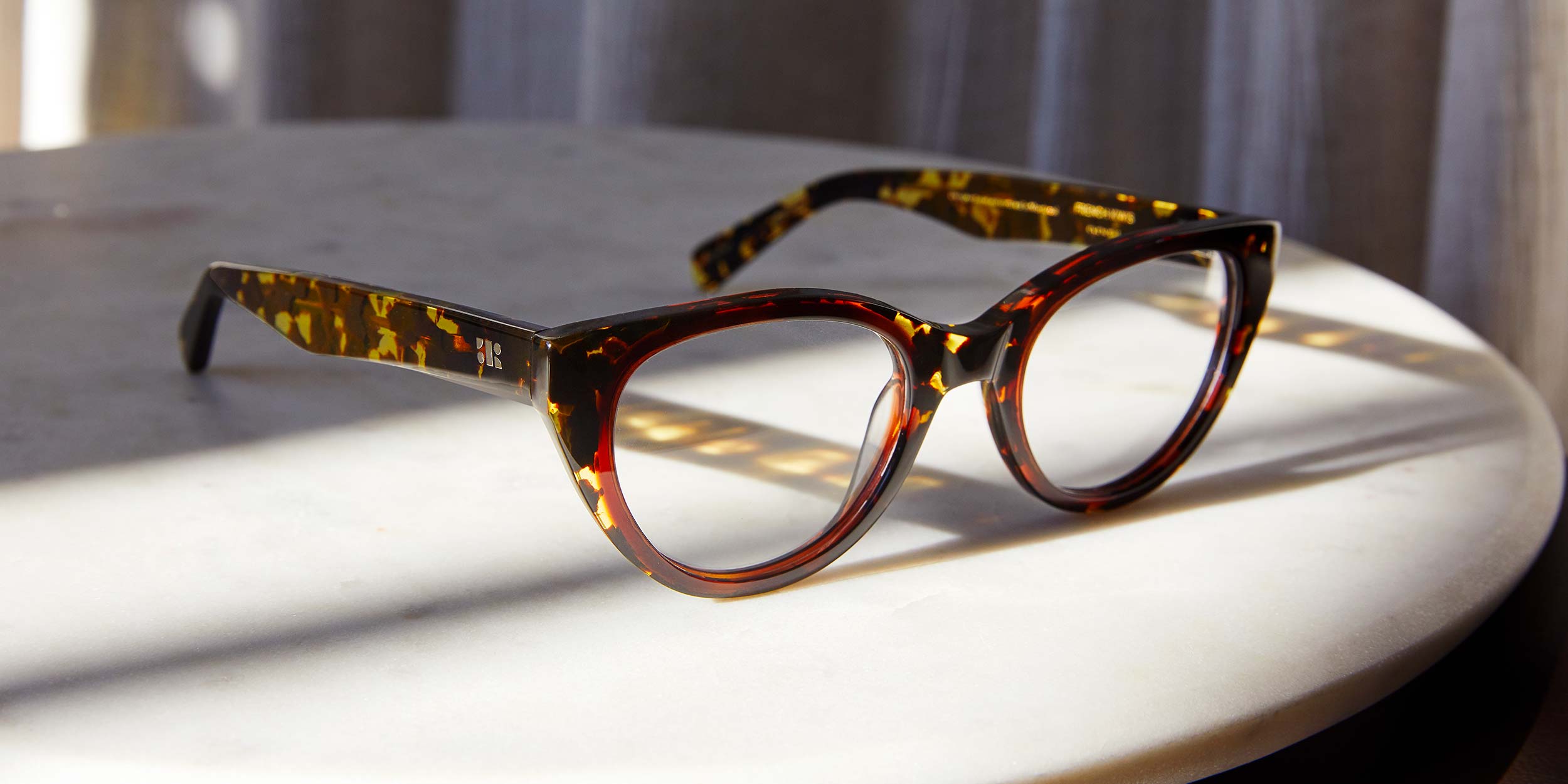 Photo Details of Colette Dark Tortoise Reading Glasses in a room
