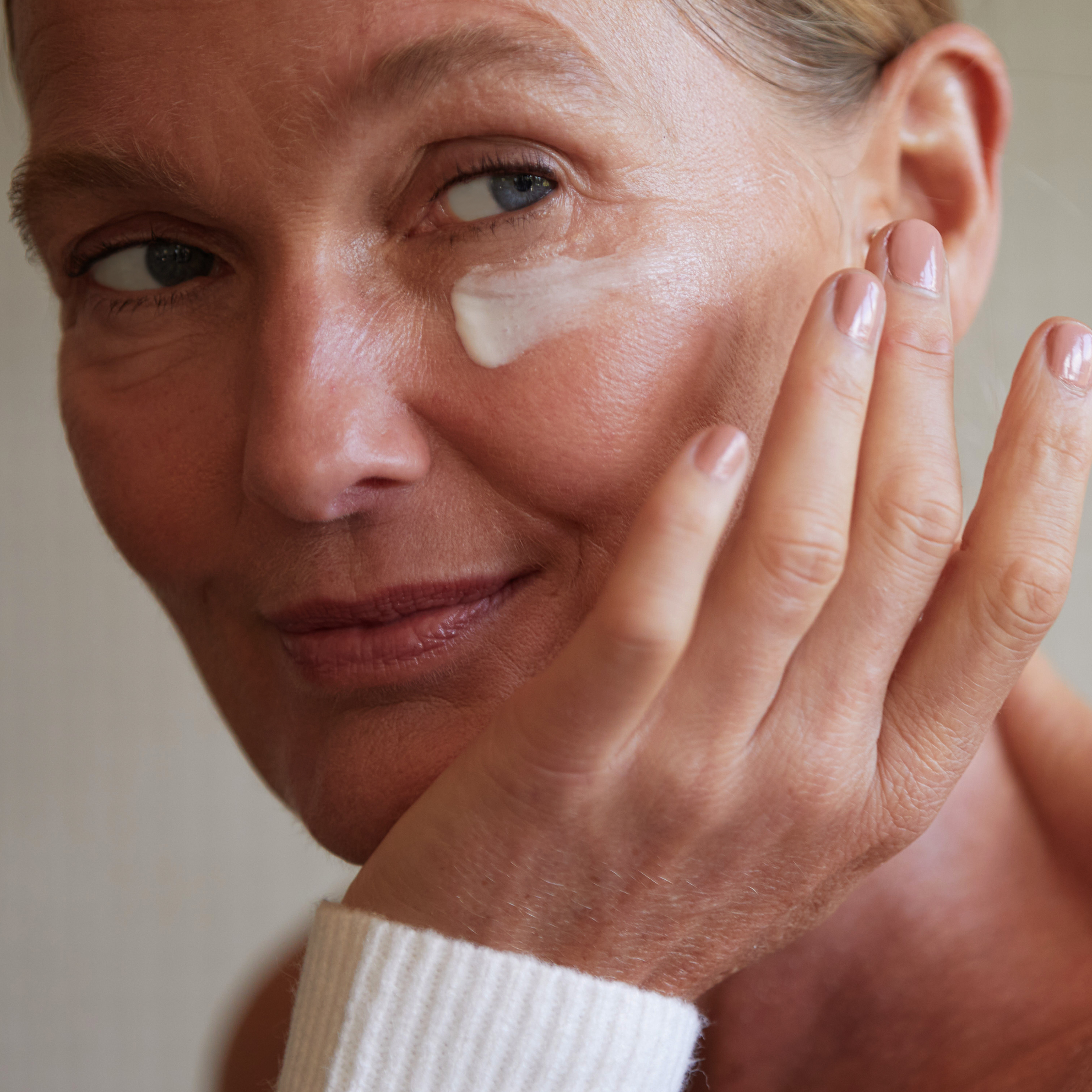 Person applying eye product to under eye area