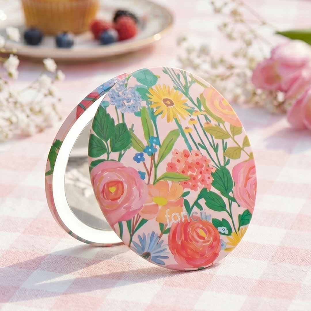 Vibrant Florals Mini Taylor Lighted Compact by Fancii gazed into by woman in a garden