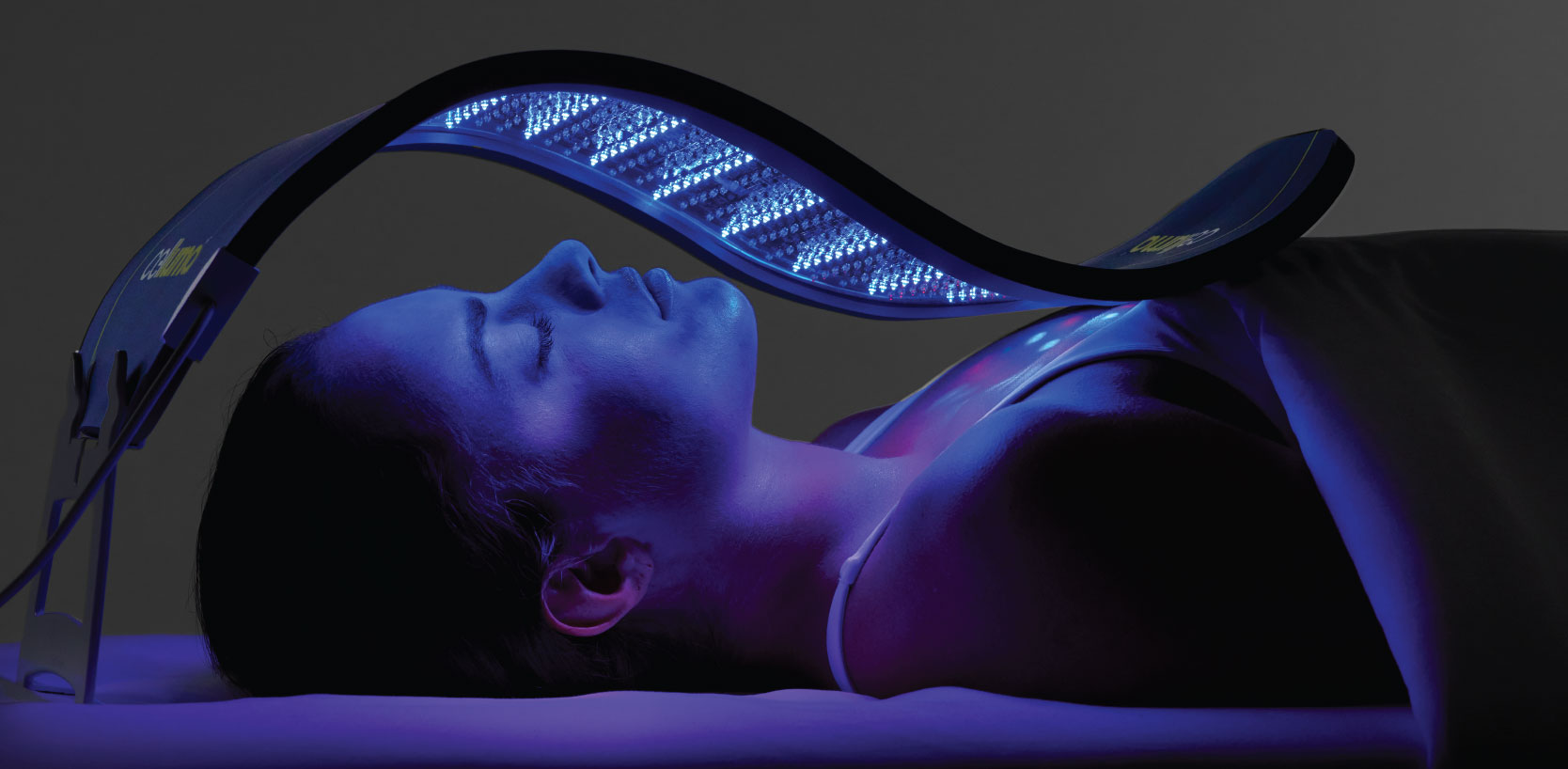 Celluma LED light therapy panel contoured to a woman's face to treat fine lines and wrinkles