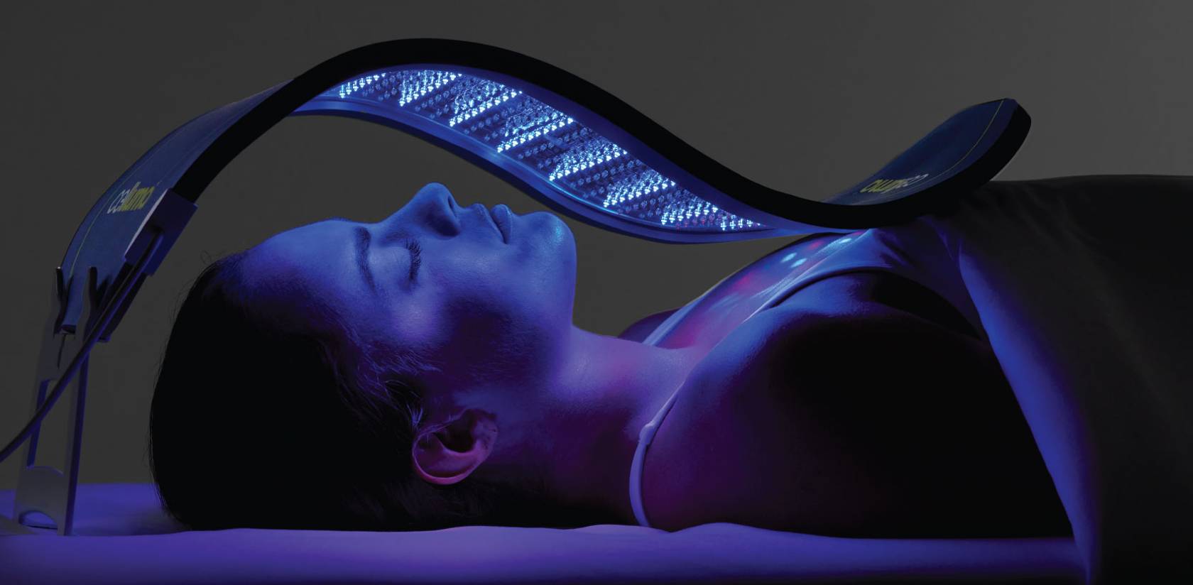 Celluma LED light therapy panel contoured to a woman's face to treat fine lines and wrinkles