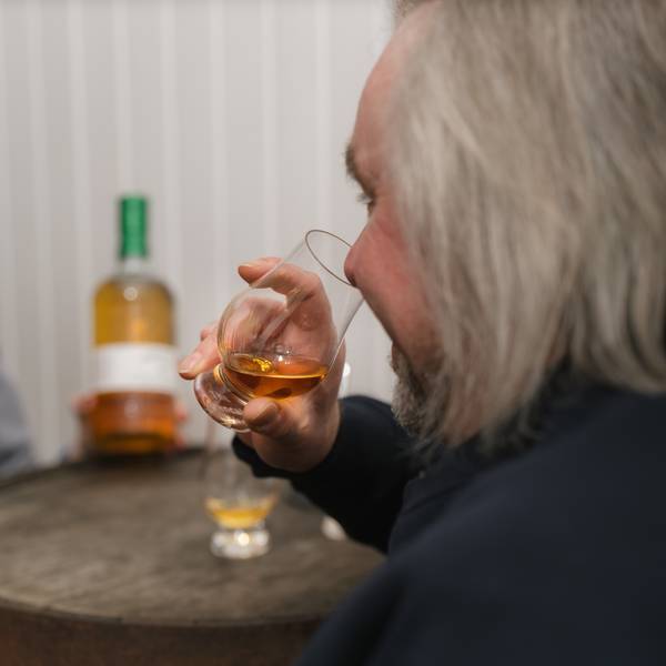 A man nosing whisky.
