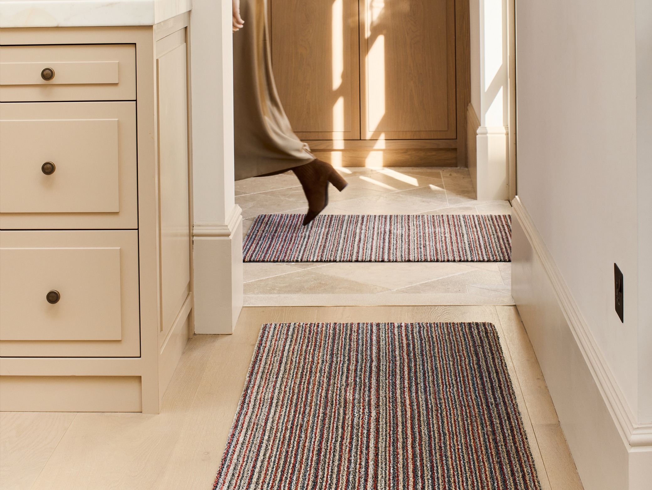 Candy Stripe Washable Doormat and Runners, styled in a hallway.