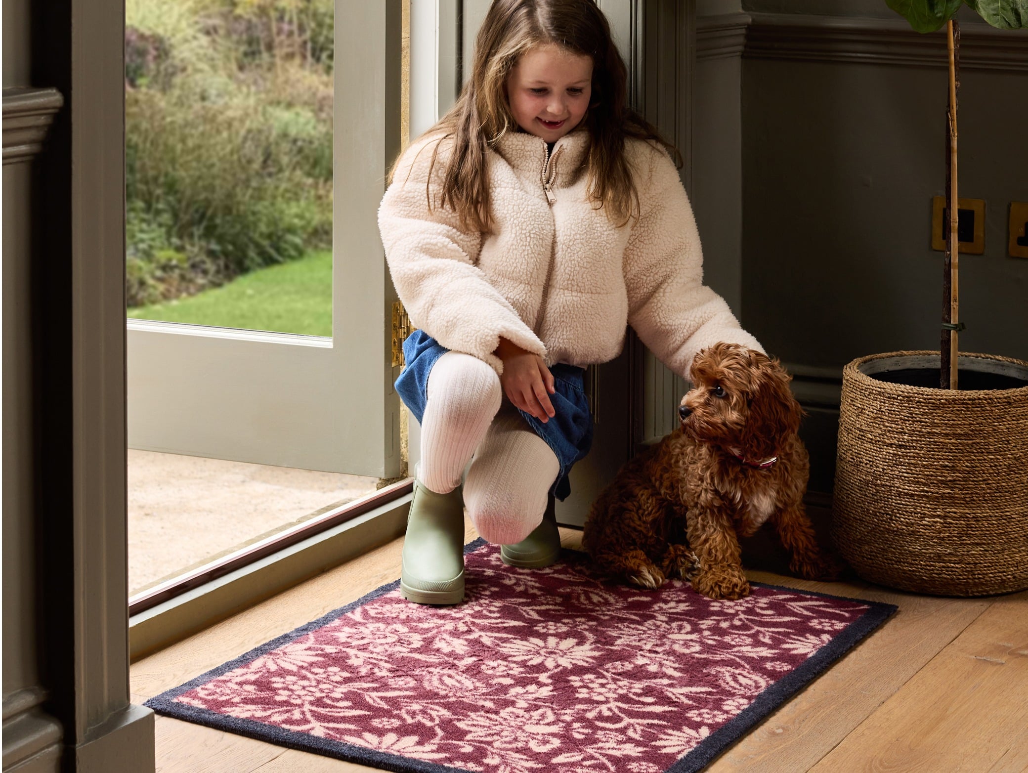 Paisley Floral Burgundy Washable Doormat in Burgundy, styled in a doorway. 