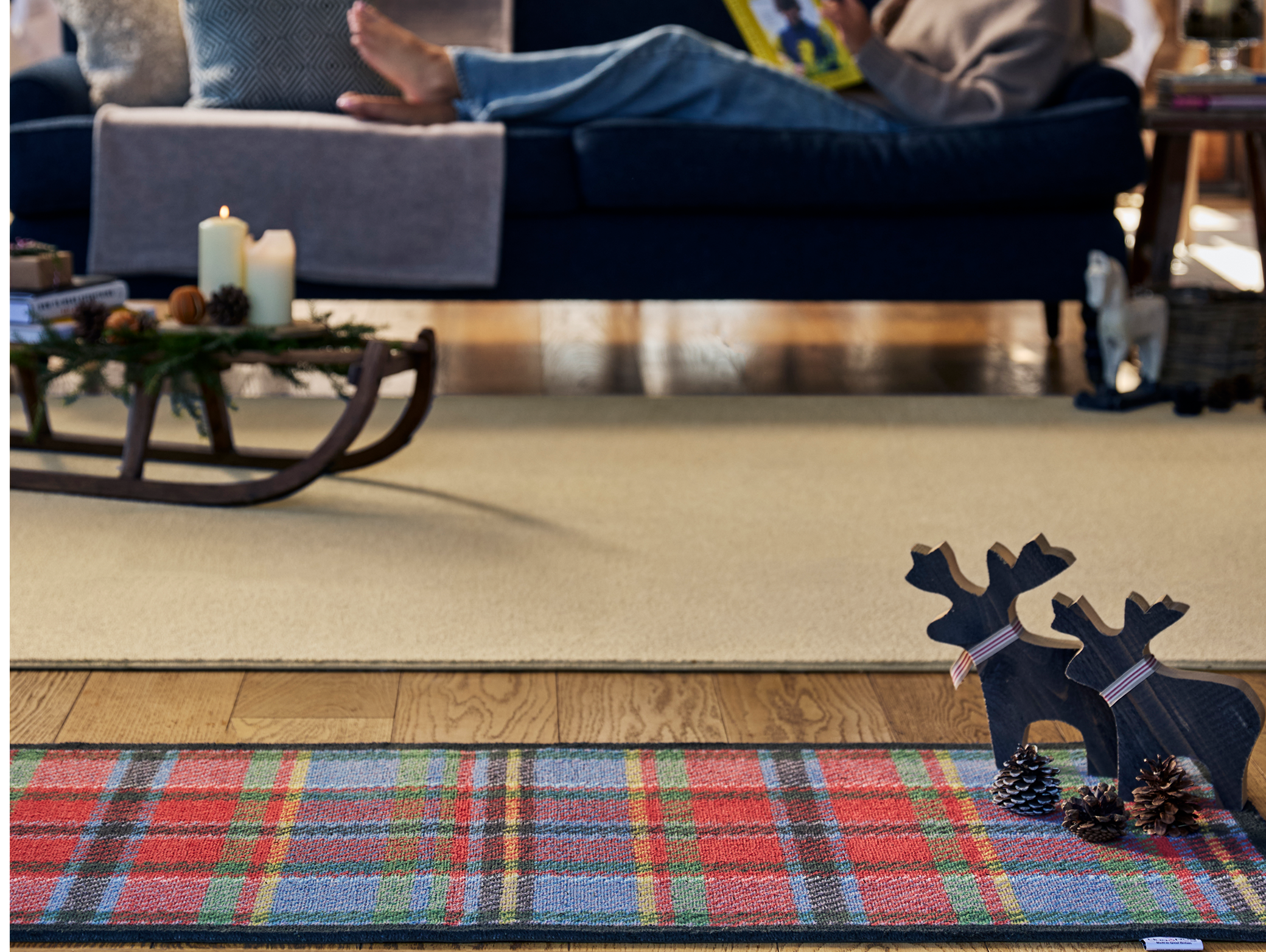 Tartan Red/Blue Washable Runner, styled on wooden flooring decorated for Christmas. 